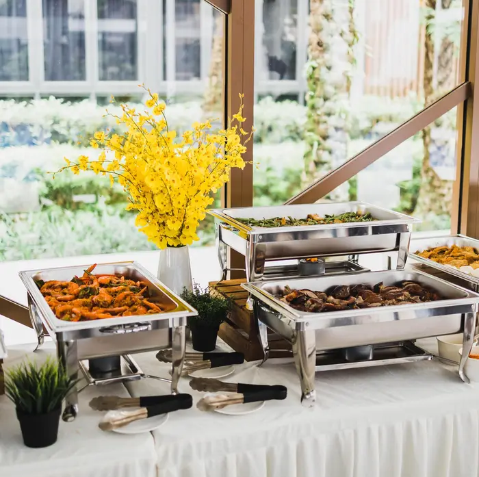 Buffet catering setup with chafing dishes at a corporate event in Singapore