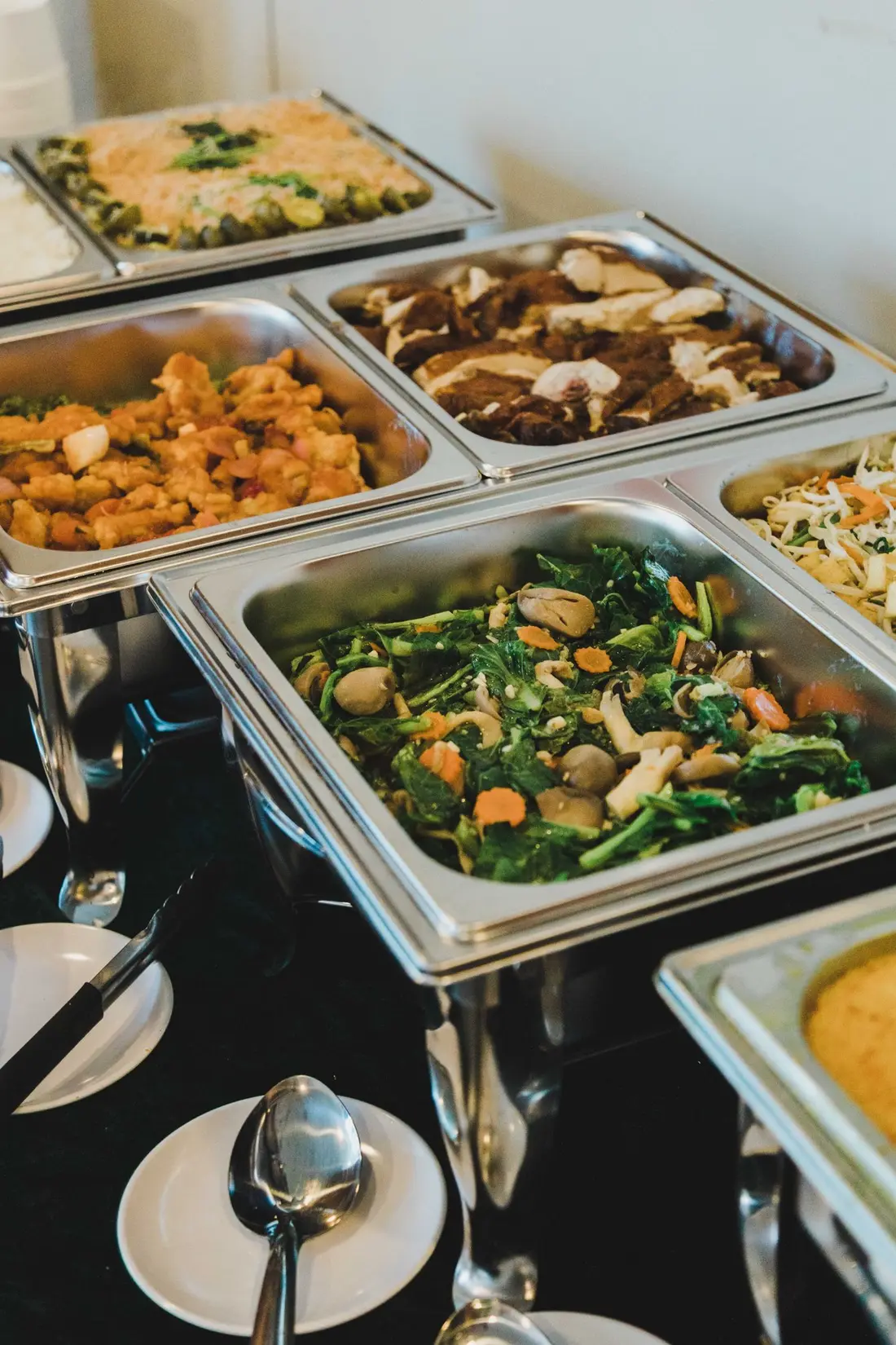 Buffet catering dishes laid out showing different menu levels in Singapore
