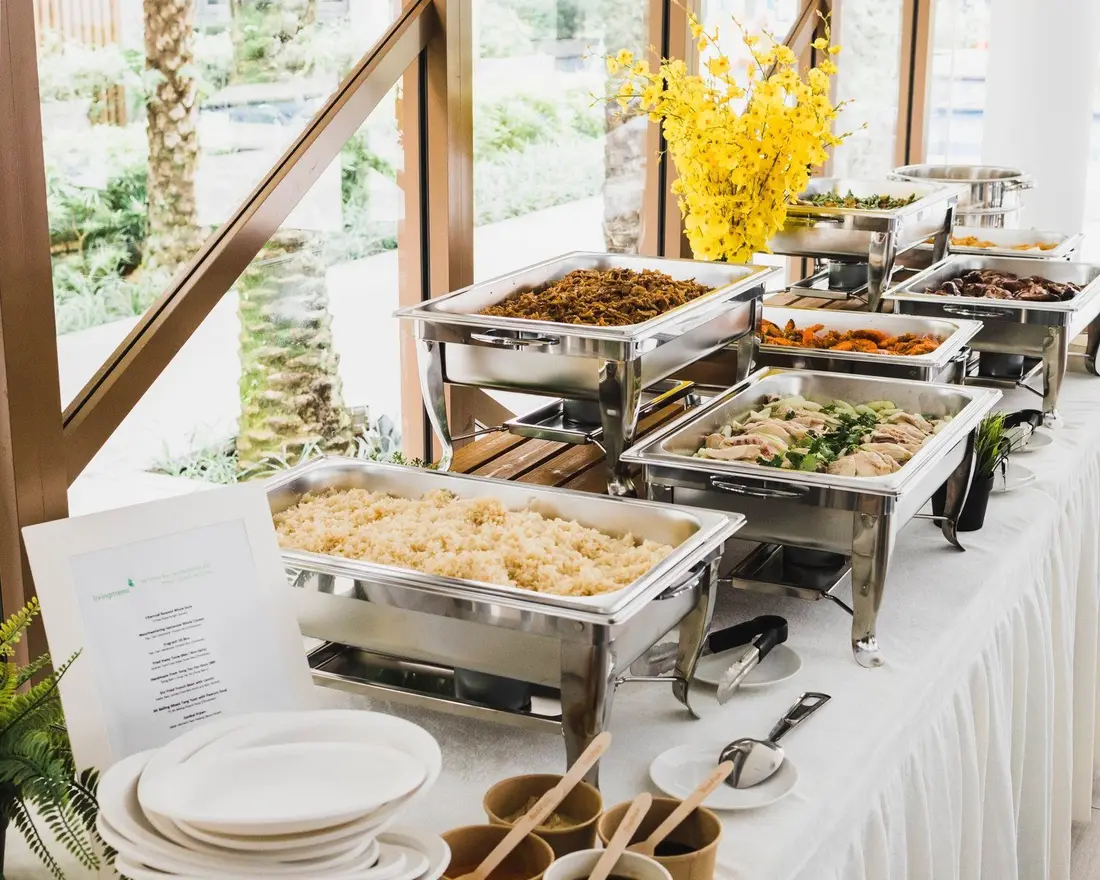 Buffet catering table being set up with warmers before an event in Singapore