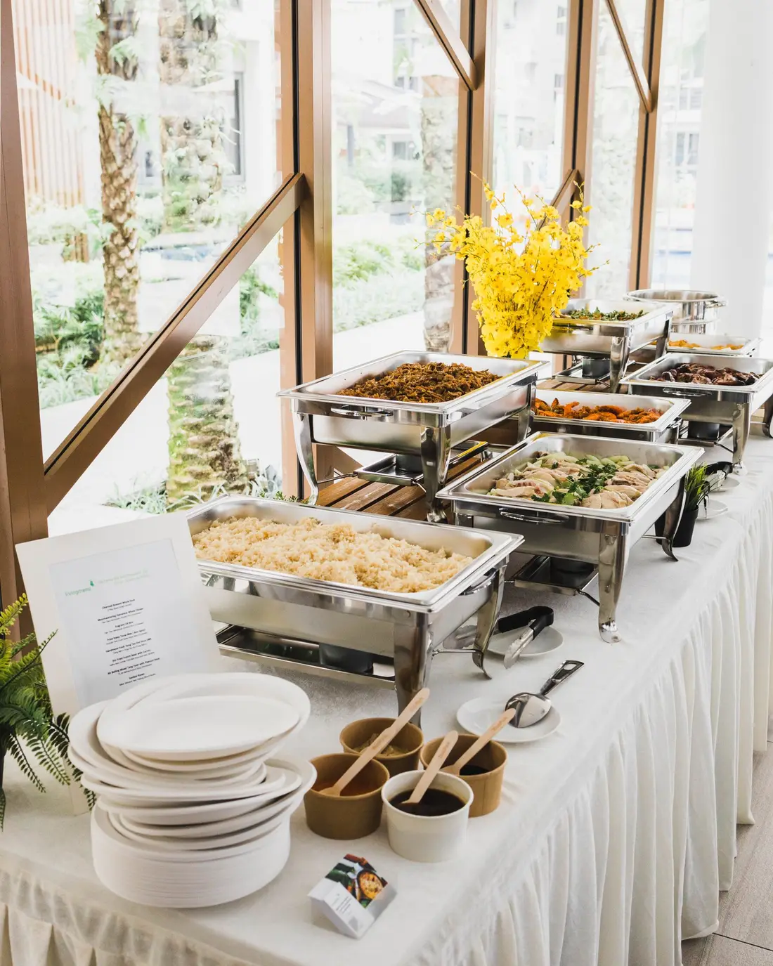 Buffet catering table being set up with warmers before an event in Singapore