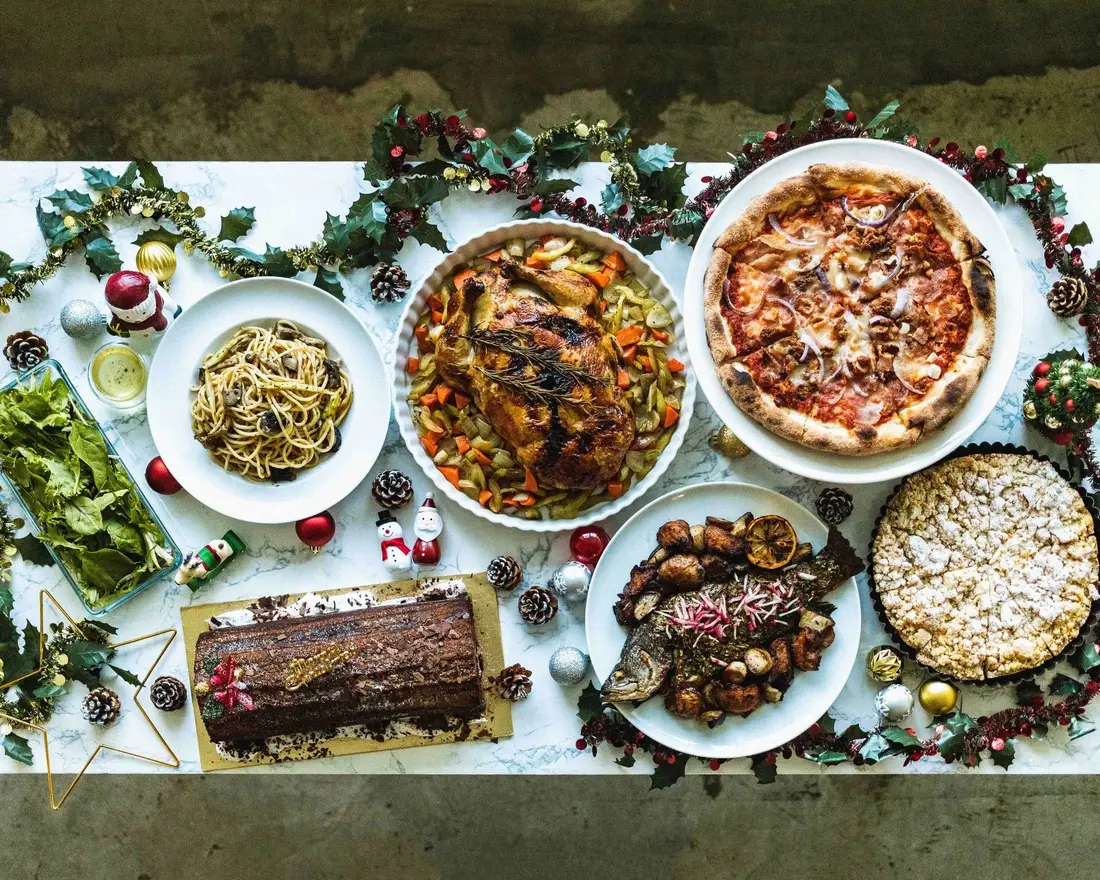 Christmas party food spread with roast, pizza and festive sides in Singapore