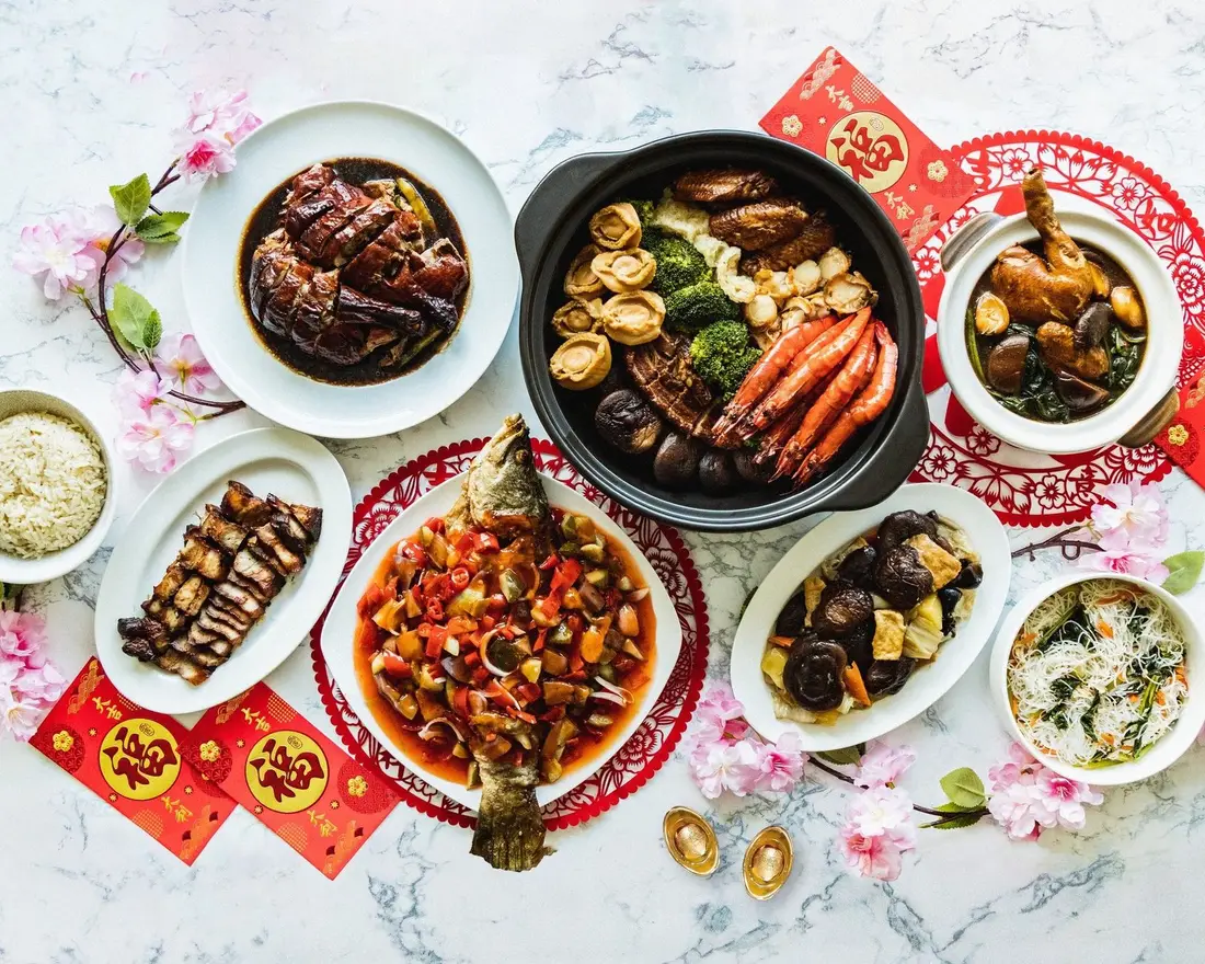 Chinese New Year catering spread with whole fish, pen cai and festive dishes in Singapore