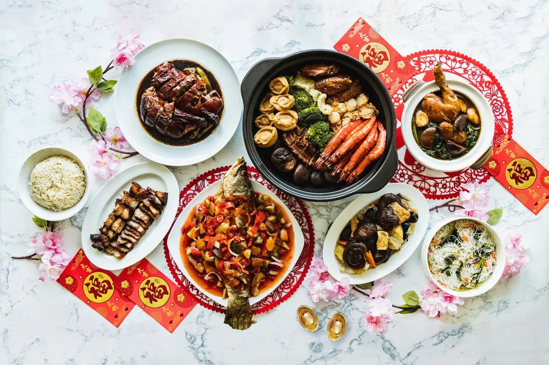 Chinese New Year catering spread with whole fish, pen cai and festive dishes in Singapore