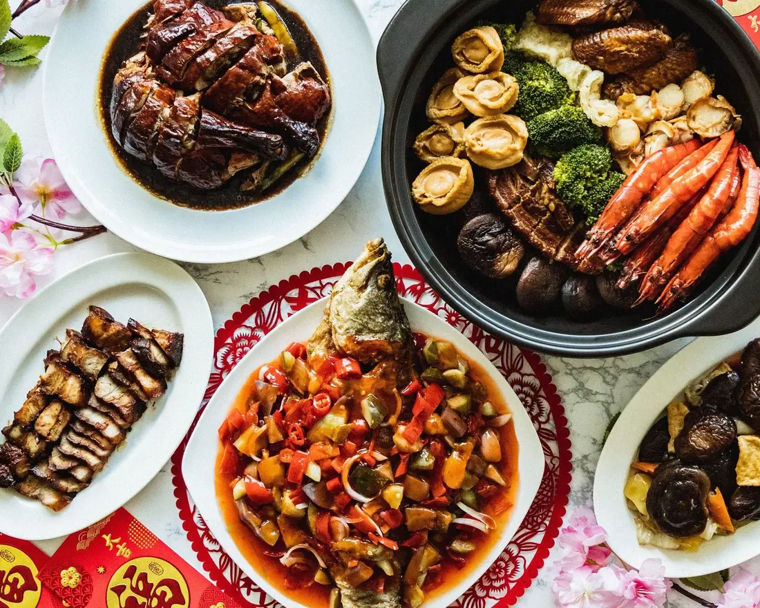 Reunion dinner catering spread with pen cai and whole fish for Chinese New Year eve in Singapore