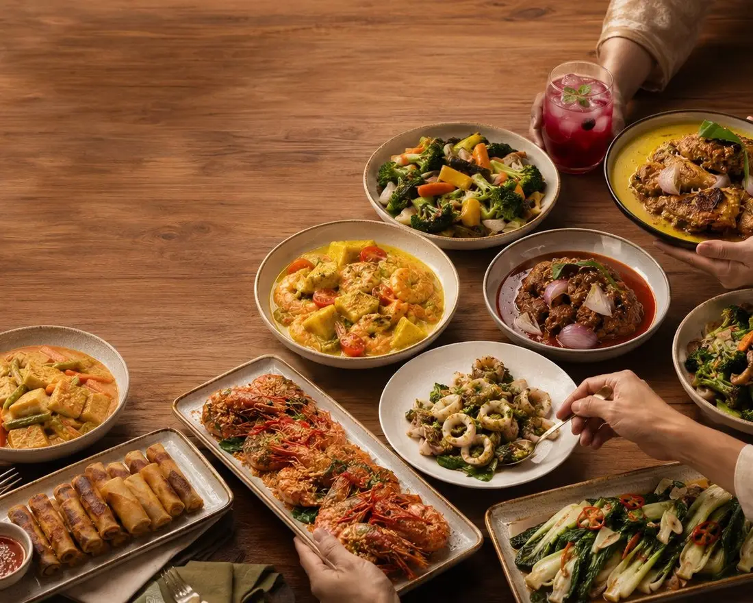 Food for a gathering laid out on a shared table in Singapore