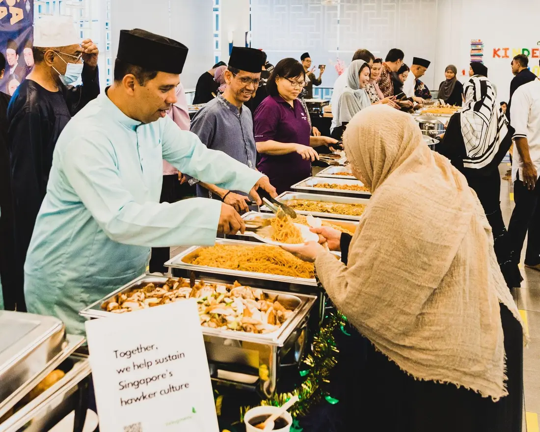 Guests serving themselves from a Hari Raya buffet catering spread in Singapore