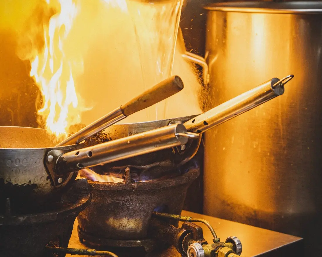 Chef cooking at a live station at an event in Singapore