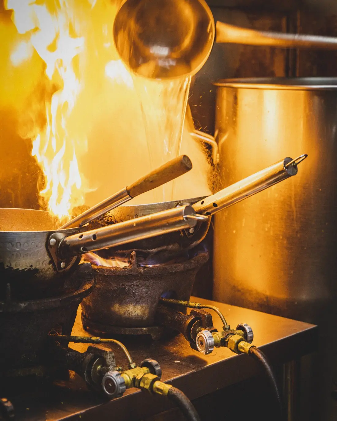 Chef cooking at a live station at an event in Singapore