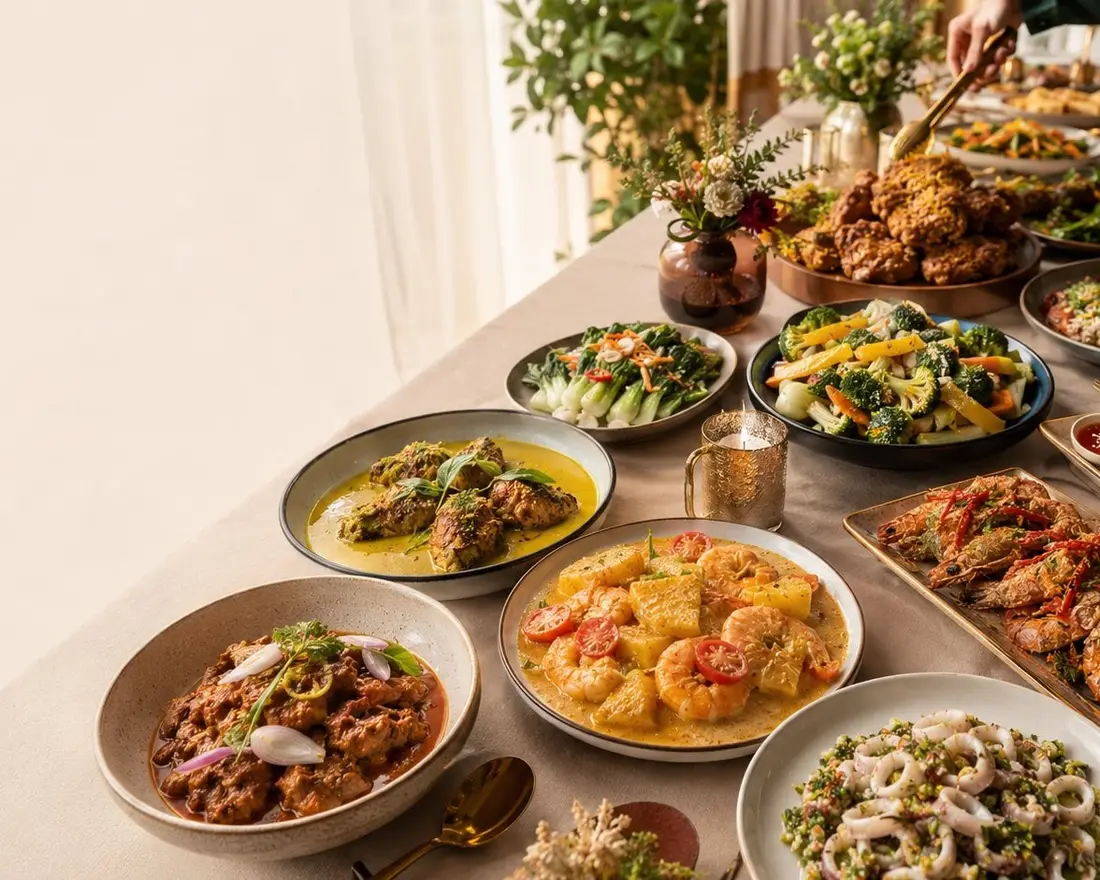Long table of local catering dishes showing mini buffet menu levels in Singapore