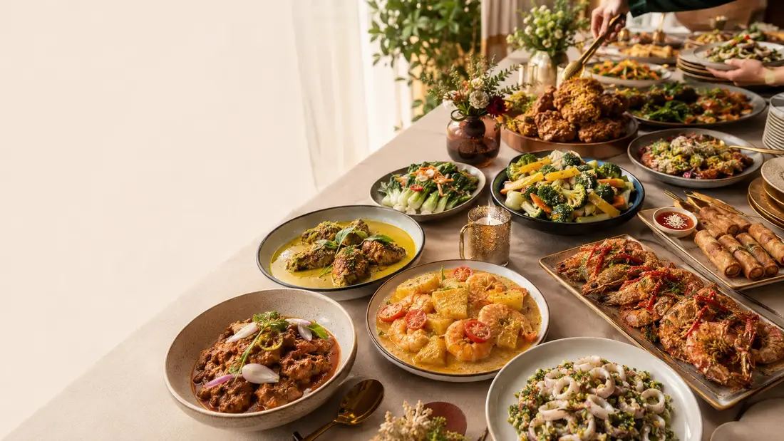 Long table of local catering dishes for a mini buffet for 50 people in Singapore