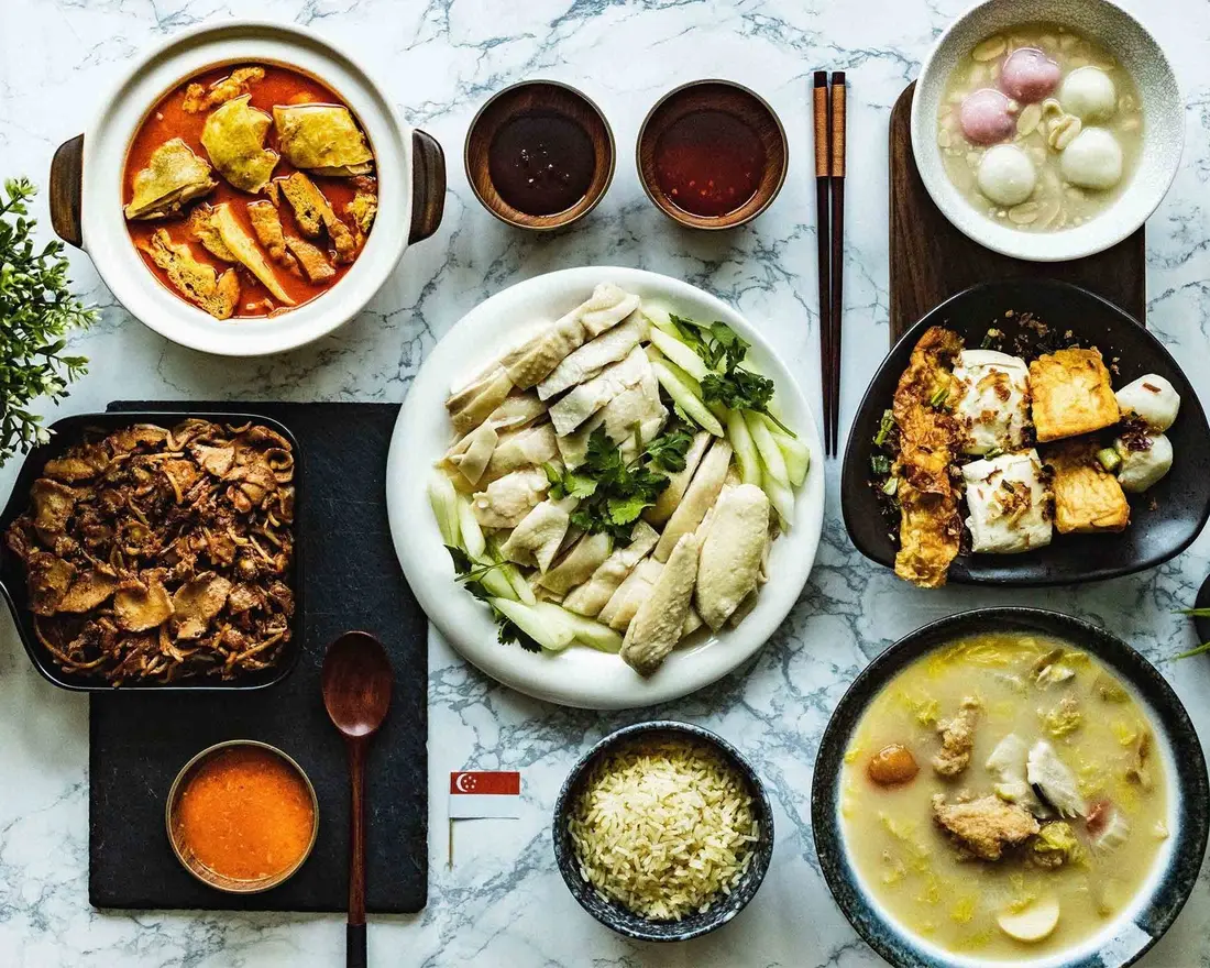 Staff canteen Singapore: a spread of local hawker dishes including chicken rice, curry, tofu and soup, the kind of variety a canteen cooked by rotating hawkers serves